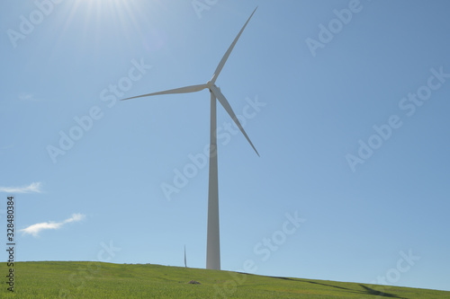 Wind turbine in a hill a sunny day with blue sky photo