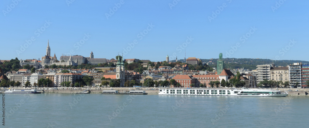 Budapest, Hungary, 15th September 2019. - View of the Budim from Pest. The Fisherman`s Bastion, the Matthias Church and Protestant church and Danube river