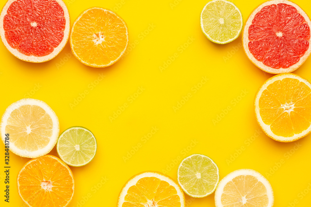 Citruses fruits on yellow background, fruit flatlay, summer minimal compositon with grapefruit, lemon, mandarin and orange . Summer color , harvest, cutting fruits with copyspace