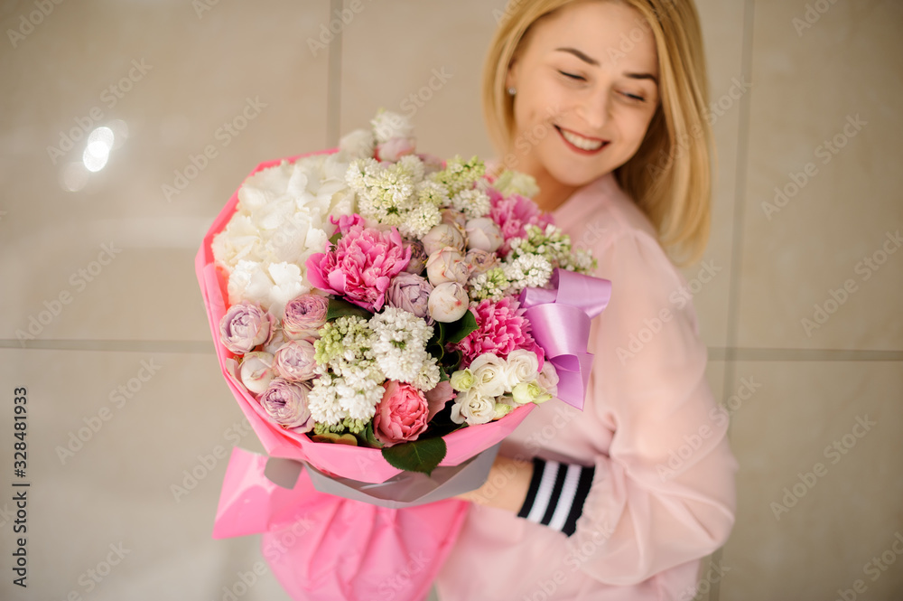 Smiling girl holding a beautiful spring bouquet in her hands. Smiling girl holding a beautiful spring bouquet in her hands.