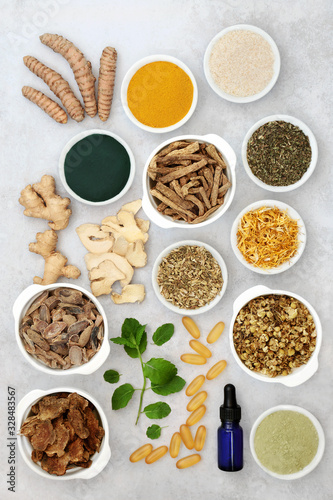 Herbs & spices used in chinese herbal medicine to treat irritable bowel syndrome with dietary supplement powders, aromatherapy essential oil & vitamin capsules. Flat lay.