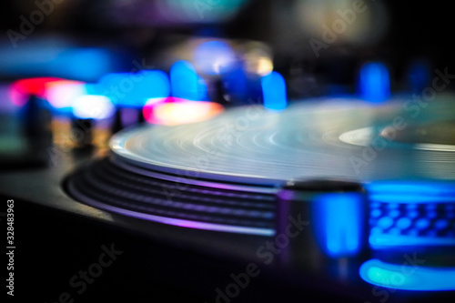 DJ vinyl players in dark nightclub, party in the dance club, DJ equipment, defocused