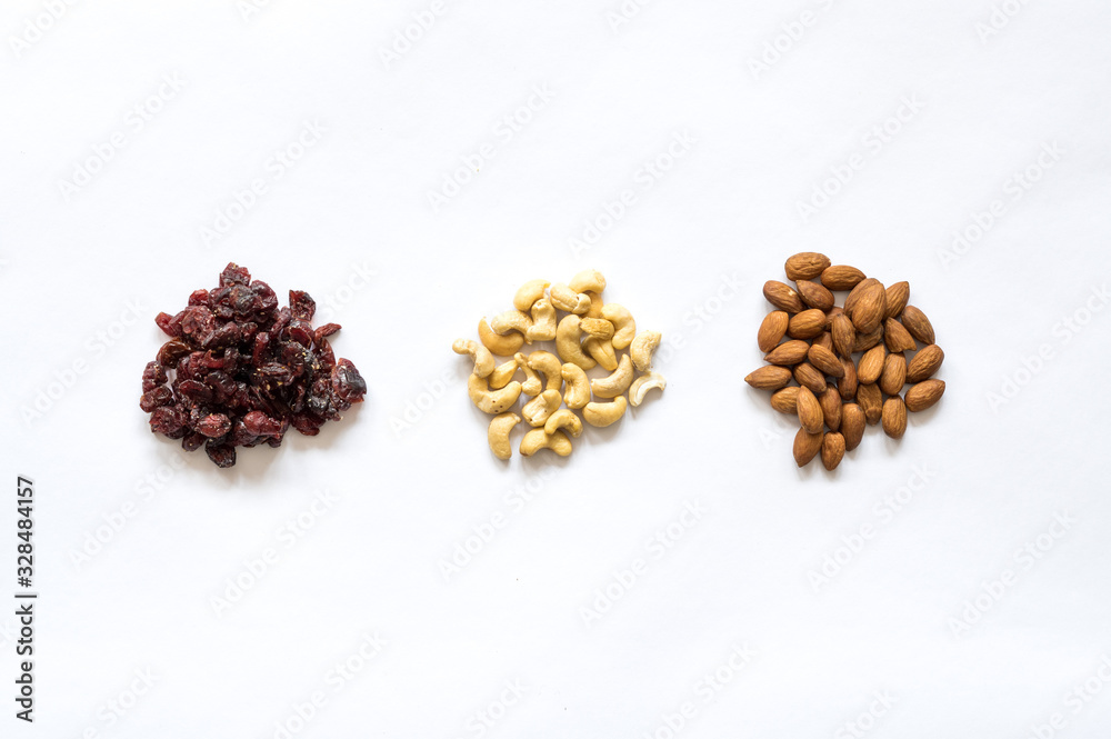 Three heaps of healthy raw food, cranberries, cashew and almonds. Three heaps of healthy raw food, cranberries, cashew and almonds.
