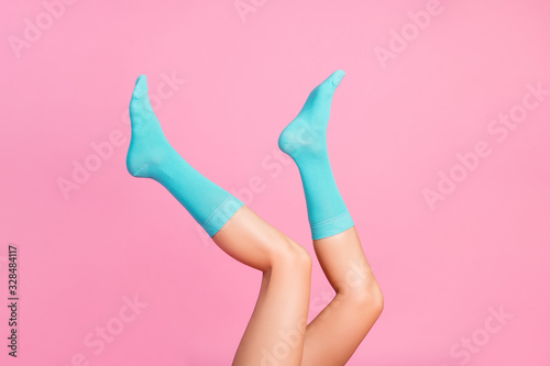 Cropped view of nice attractive long lovely healthy legs wearing bright blue socks girlfriend 8 March day holiday sale discount isolated over pink pastel color background