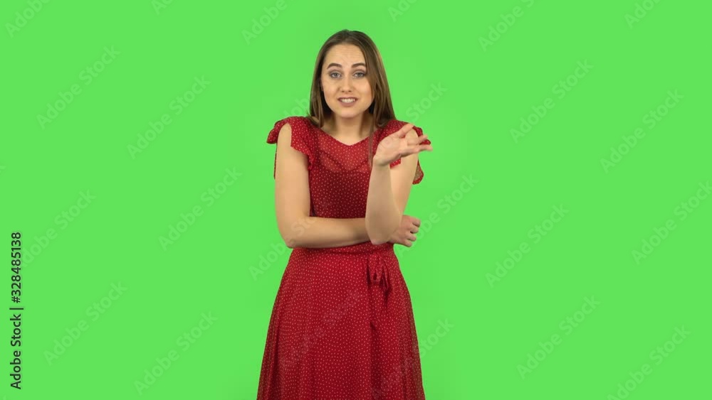 Tender girl in red dress communicates with someone in a friendly manner. Green screen Tender girl in red dress communicates with someone in a friendly manner. Green screen