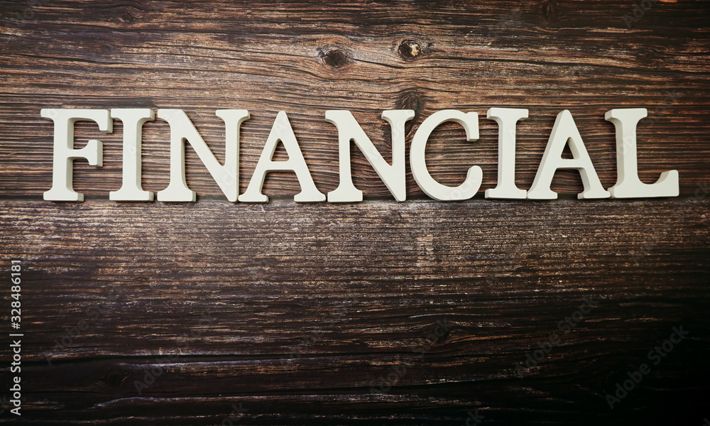 Fototapeta premium Financial alphabet letter on wooden background