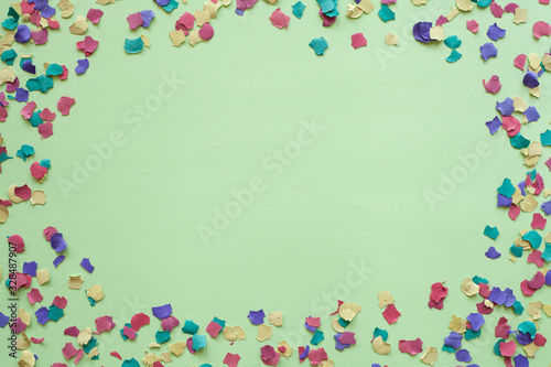 Purim carnival green background with colorful confetti