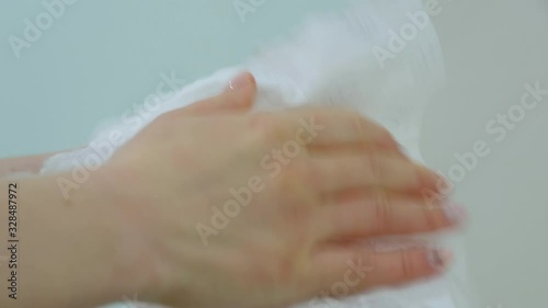 nurse wipes hands with a paper towel