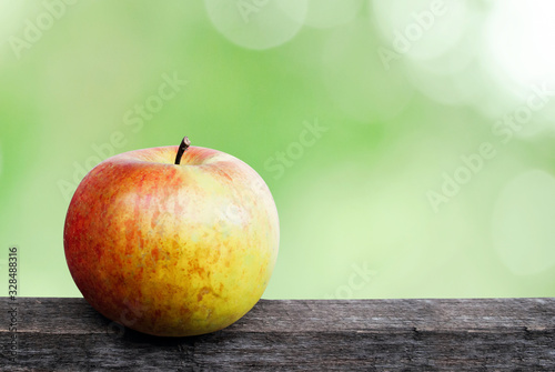 Close up of an organic apple fruit with outdour Background photo