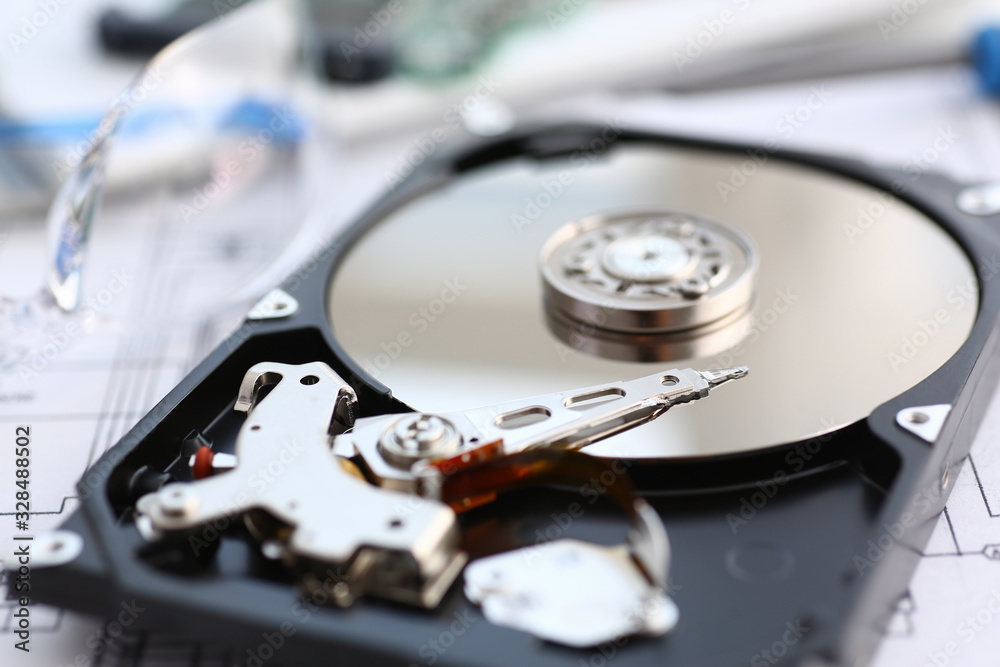 Hard drive from computer or laptop lies on the table in the repair shop. Performs fault diagnostics and performs urgent repairs recovery of lost data during deletion HDD closeup Hard drive from computer or laptop lies on the table in the repair shop. Performs fault diagnostics and performs urgent repairs recovery of lost data during deletion HDD closeup