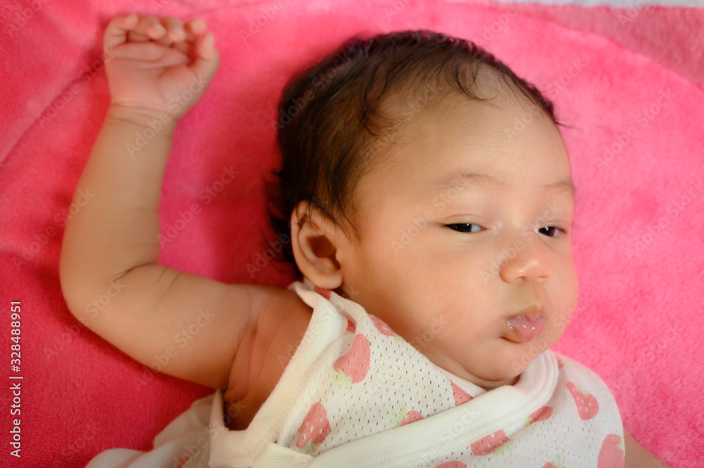 Close up portrait of funny asia female baby on the pink background. Happy asia kid and healthy concept wallpaper. Joy and relaxation.