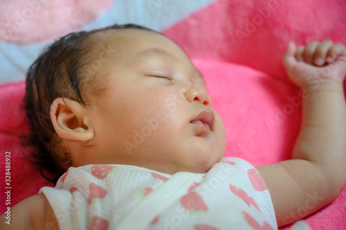 Close up portrait of funny asia female baby on the pink background. Happy asia kid and healthy concept wallpaper. Joy and relaxation.