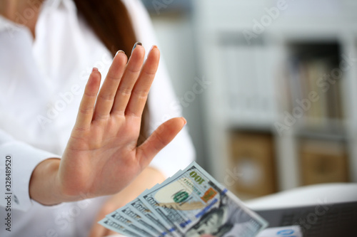 Tableau sur toile Male arm pay bunch of hundred dollars bills to office clerk closeup