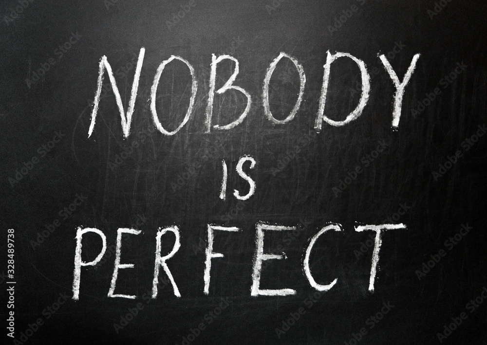 Nobody is perfect written in white chalk on a black chalkboard Nobody is perfect written in white chalk on a black chalkboard