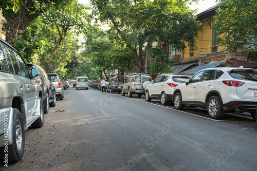 Parallel parking cars on urban street. Outdoor parking on road © Hanoi Photography