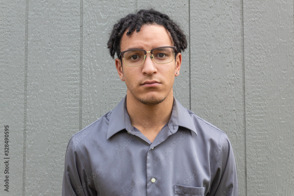 Sad young millennial man facing forward close view, African American biracial male with natural hair in short dreadlocks, horizontal aspect Sad young millennial man facing forward close view, African American biracial male with natural hair in short dreadlocks, horizontal aspect