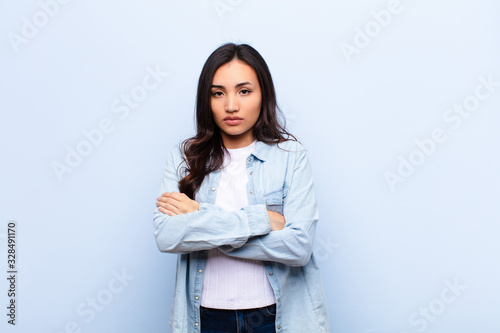 Fotografie young latin pretty woman feeling displeased and disappointed, looking serious, a