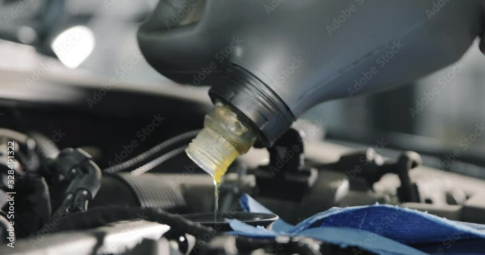 Car Service Worker Changes Oil In The Car Car Service Worker Changes Oil In The Car