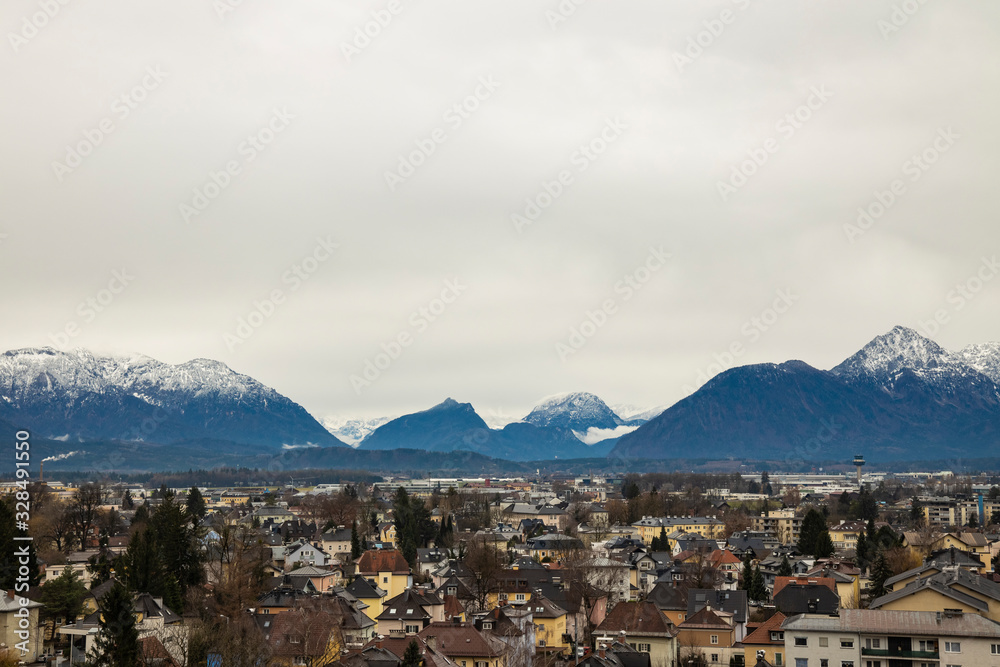 central European city top view moody colors and cloudy weather time Alps mountains scenic background view