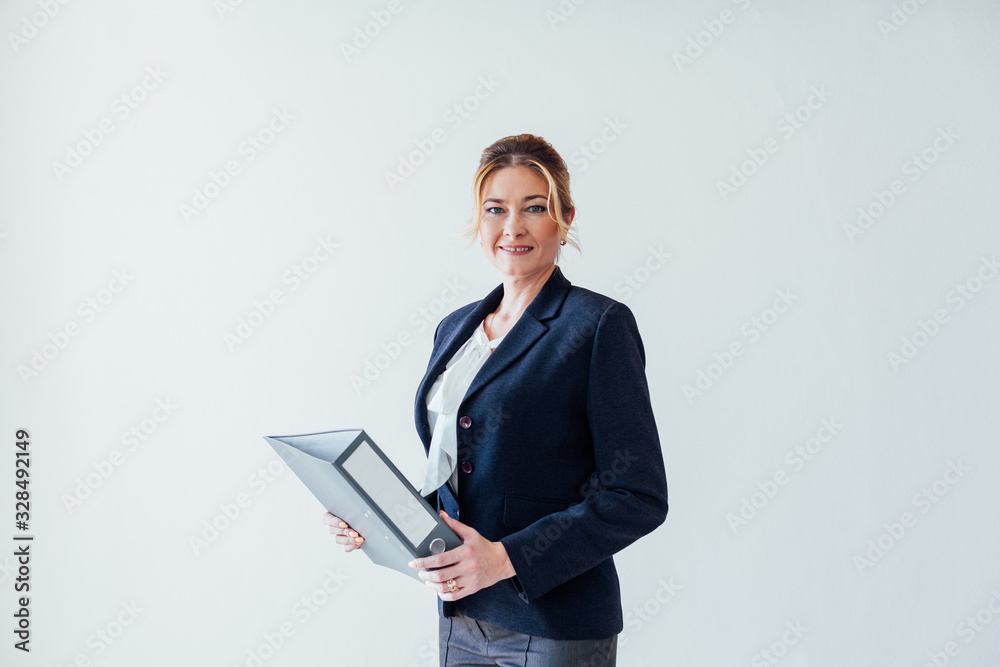 businesswoman in business suit with folders for papers at work in the office businesswoman in business suit with folders for papers at work in the office