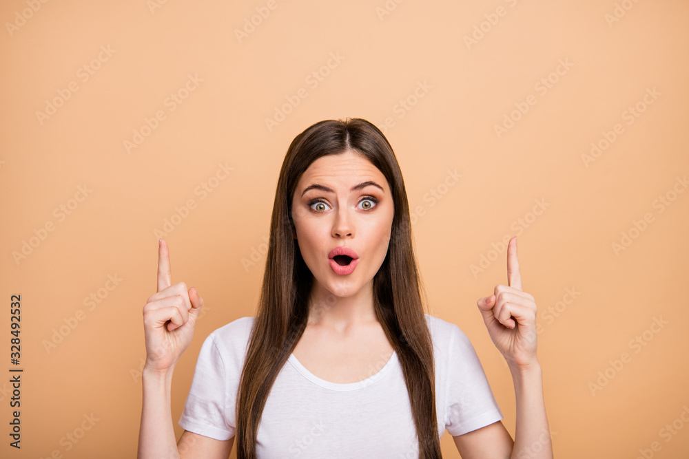 Close up photo astonished girl promoter point index finger up copyspace suggest select incredible sales option impressed scream wow omg wear stylish clothing isolated beige color background Close up photo astonished girl promoter point index finger up copyspace suggest select incredible sales option impressed scream wow omg wear stylish clothing isolated beige color background