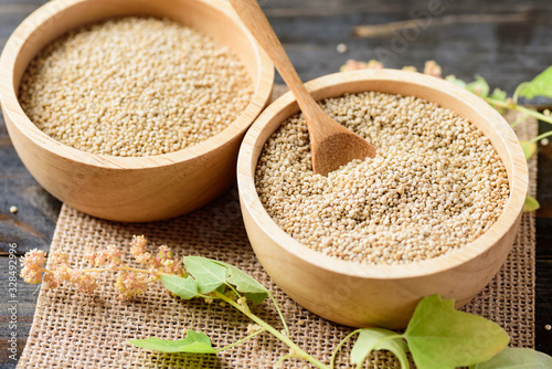 Organic raw brown quinoa seed (Chenopodium quinoa) in a bowl with spoon, healthy food photo