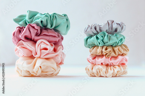 Lot of Colorful silk Scrunchies on white. Luxury Hairdressing tools and accessories. Hair Scrunchies, Elastic HairBands, Bobble Sports Scrunchie Hairband