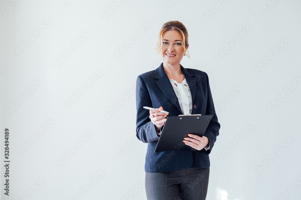 businesswoman in business suit with paperwork documents at work in the office businesswoman in business suit with paperwork documents at work in the office