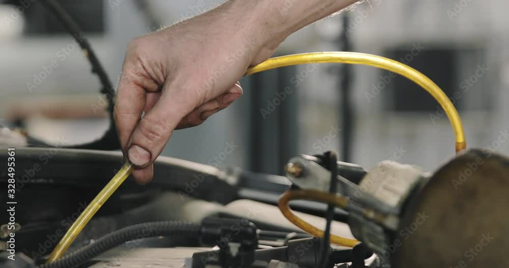 Mechanic Draining Old Brake Fluid From A System During The Service