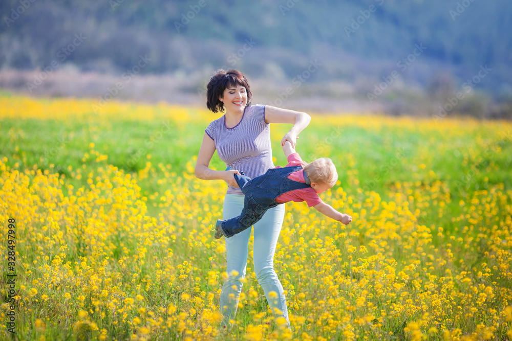 Happy woman and child in the blooming spring garden. Happy woman and child in the blooming spring garden.