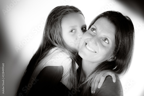 Mother enjoy love kiss little kid daughter in white and black vintage picture photo