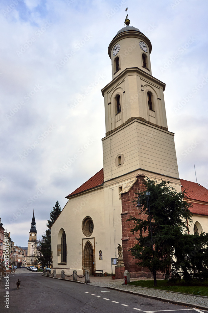 Naklejka premium Church bell tower and town hall tower in the city of Bolków in Poland.