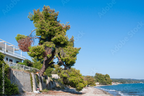 Halkidiki, Greece - September 03,2019: A beautiful Greek beach on the Aegean Sea in Halkidiki. Private house and private beach.