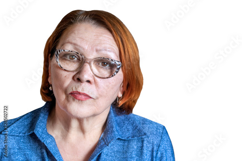 Portret of serious senior woman in glasses looking in the camera isolated on the white background