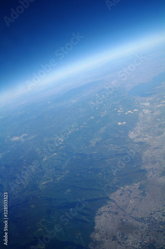 Obraz na płótnie View from the plane window to the clouds and the earth w salonie