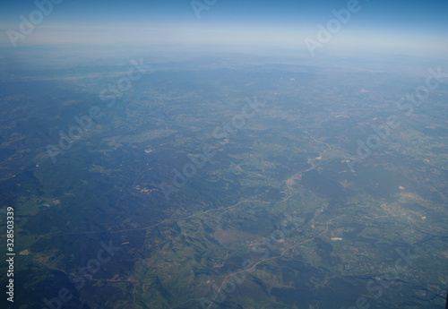 Obraz na płótnie View from the plane window to the clouds and the earth w salonie