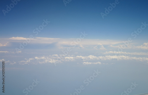 Obraz na płótnie clouds and blue sky seen from plane w salonie