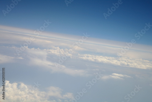 Obraz na płótnie clouds and blue sky seen from plane w salonie