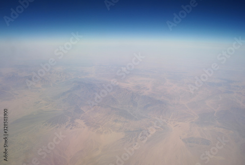 Obraz na płótnie View from the plane window to the clouds and the earth w salonie