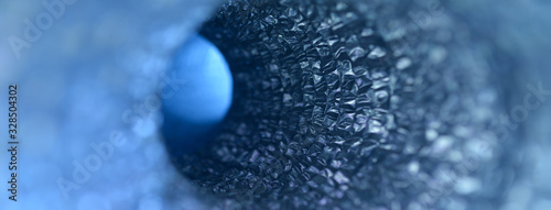 Interior of blue abstract pipe with light coming from circular hole at the end. Abstract science fiction conceptual background banner.