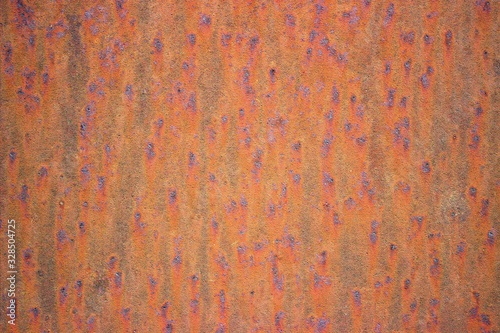 Brown rusted metal surface with dark spots © Римма Мельникова