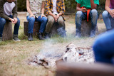 Close Up Of Children On Outdoor Activity Camping Trip Sit Around Camp Fire Together