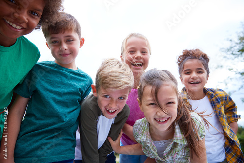 Portrait Of Children On Outdoor Activity Camping Trip Having Fun Playing Game Together