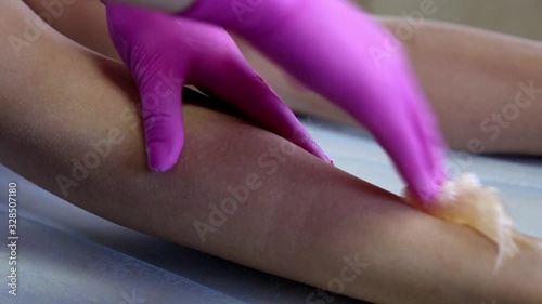 Wallpaper Mural azulene depilation. wax hair removal, shugaring. concept of smooth skin without hair. azulene color. the master puts azulene on the girls legs Torontodigital.ca