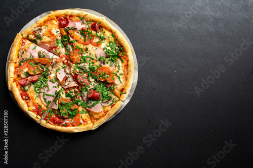 Pizza on dark background. Pizza menu. Space for text.