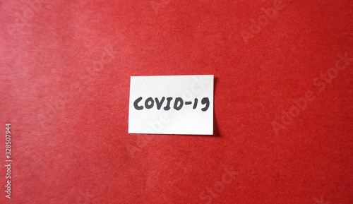  Notepad with words CORONA VIRUS and medicines on red background, flat lay. Space for text