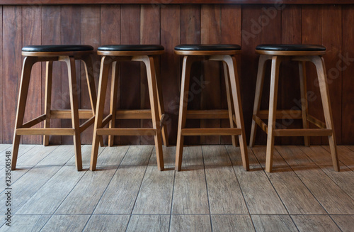 Row of wooden chairs or stools vintage in front of counter bar interior retro style decoration
