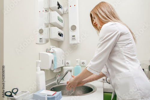 girl dentist doctor washes hands after treatment