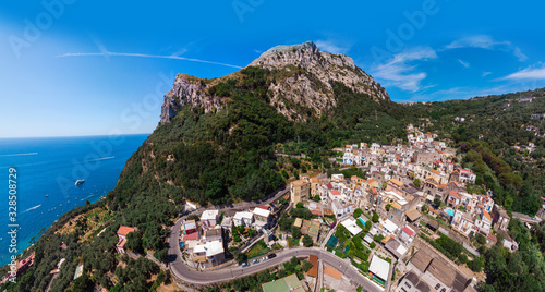 Aerial view Nerano village, Infrastructure of a small town in the south of Italy, old houses, tight construction, mountain and sea in the background. Amalfi Coast, Italy
