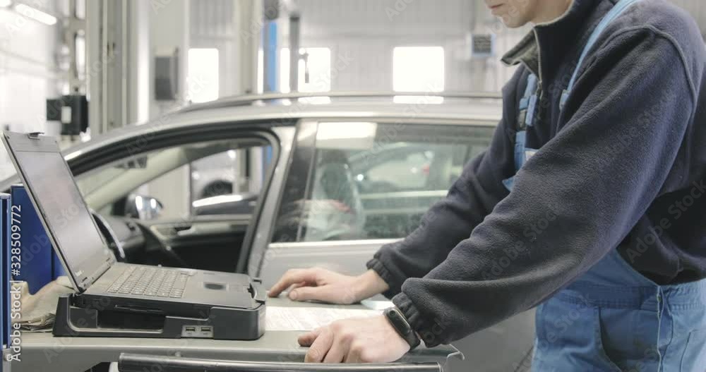 Professional Car Mechanic, Doing Computer Diagnostic . Auto Repair Concept. Professional Car Mechanic, Doing Computer Diagnostic . Auto Repair Concept.